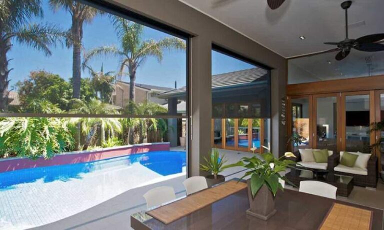 Outdoor roller shades installed on a covered patio in Augusta