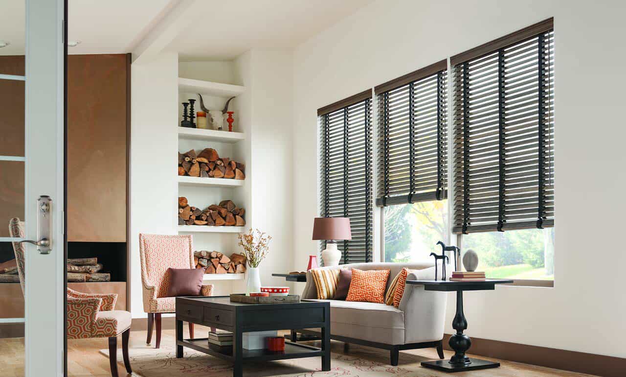 dining room with dark rattan chairs and light tan bamboo blinds on windows