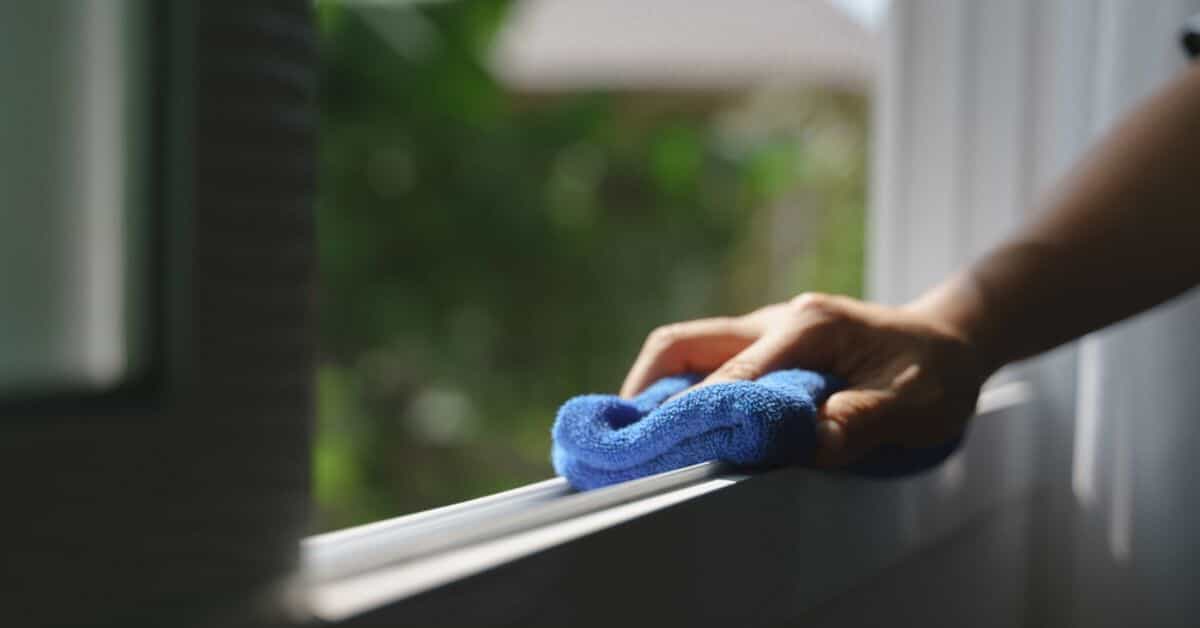 corner of room with brick walls and formal chair with bamboo blinds on window