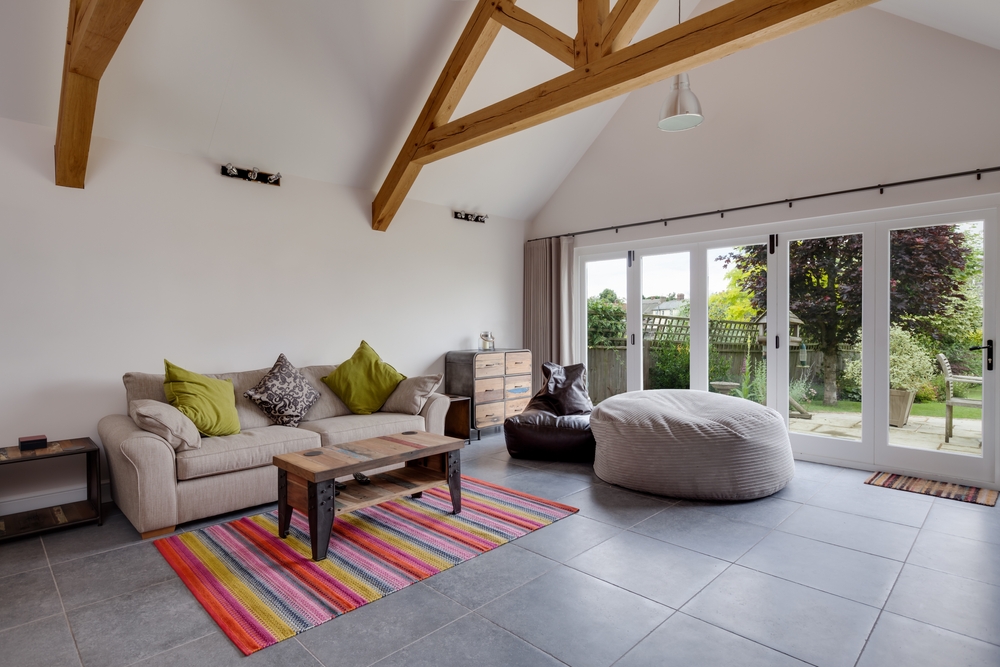 bi-fold patio doors with drapes on either side and a rail above the doors